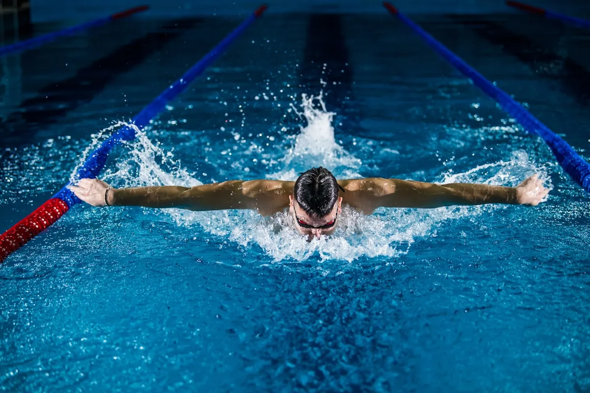 A butterfly swimmer mid-stroke.